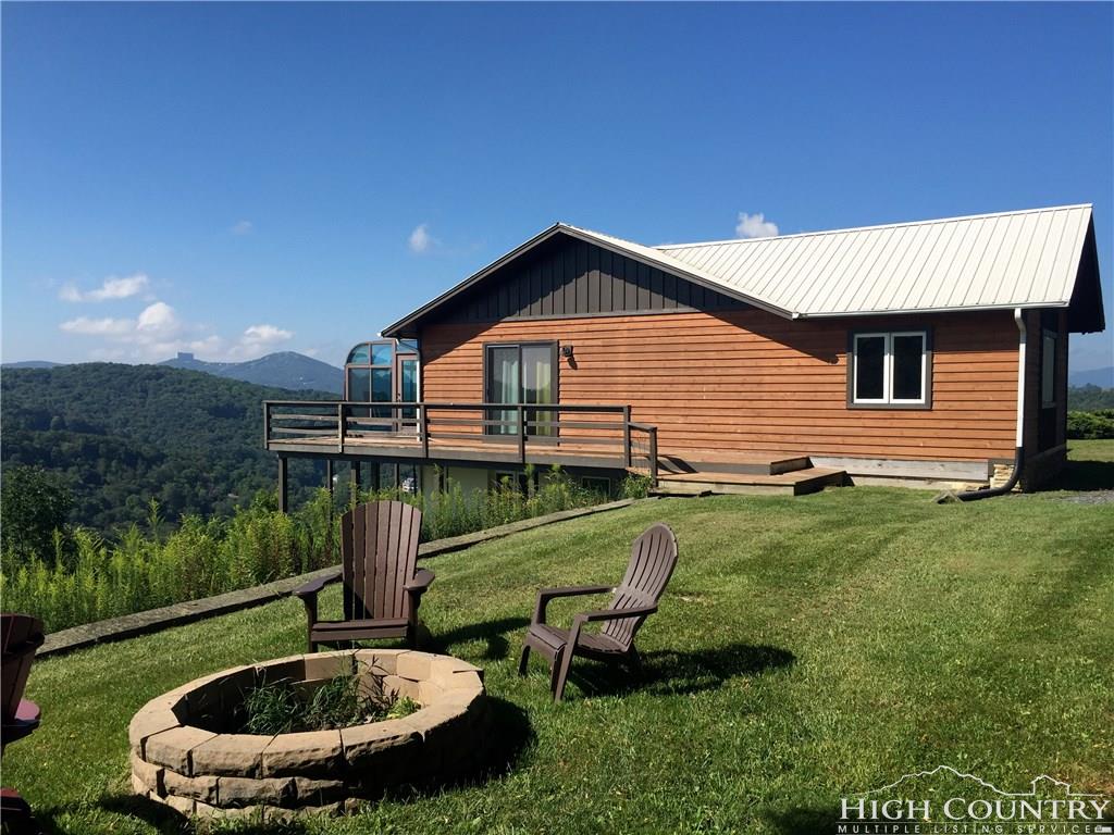 1071 Elk Hill Road Banner Elk, NC 28604 - Photo 1 of 28 a backyard of a house with table and chairs