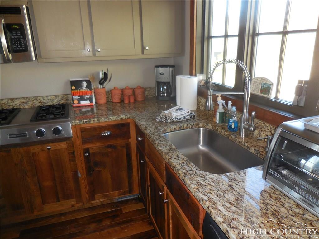 1071 Elk Hill Road Banner Elk, NC 28604 - Photo 12 of 28 a kitchen with granite countertop a sink stove and cabinets