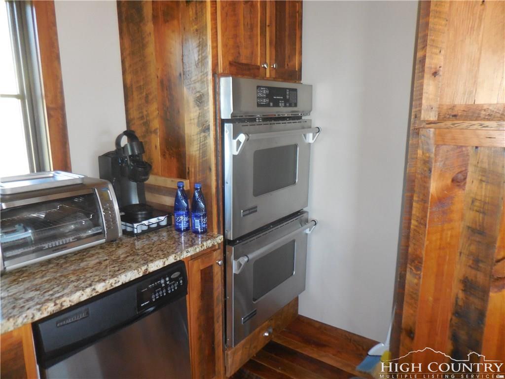1071 Elk Hill Road Banner Elk, NC 28604 - Photo 13 of 28 a kitchen with stainless steel appliances granite countertop a sink stove and refrigerator