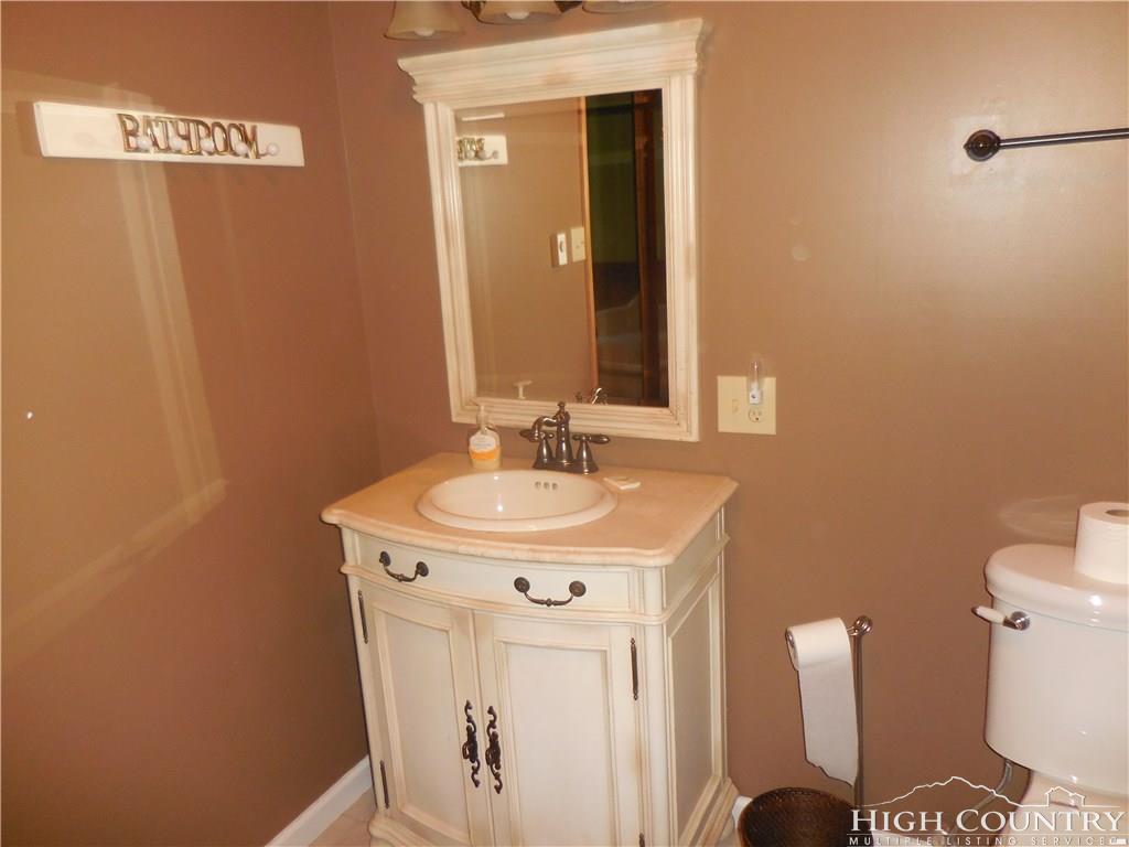 1071 Elk Hill Road Banner Elk, NC 28604 - Photo 16 of 28 a bathroom with a sink a toilet and mirror