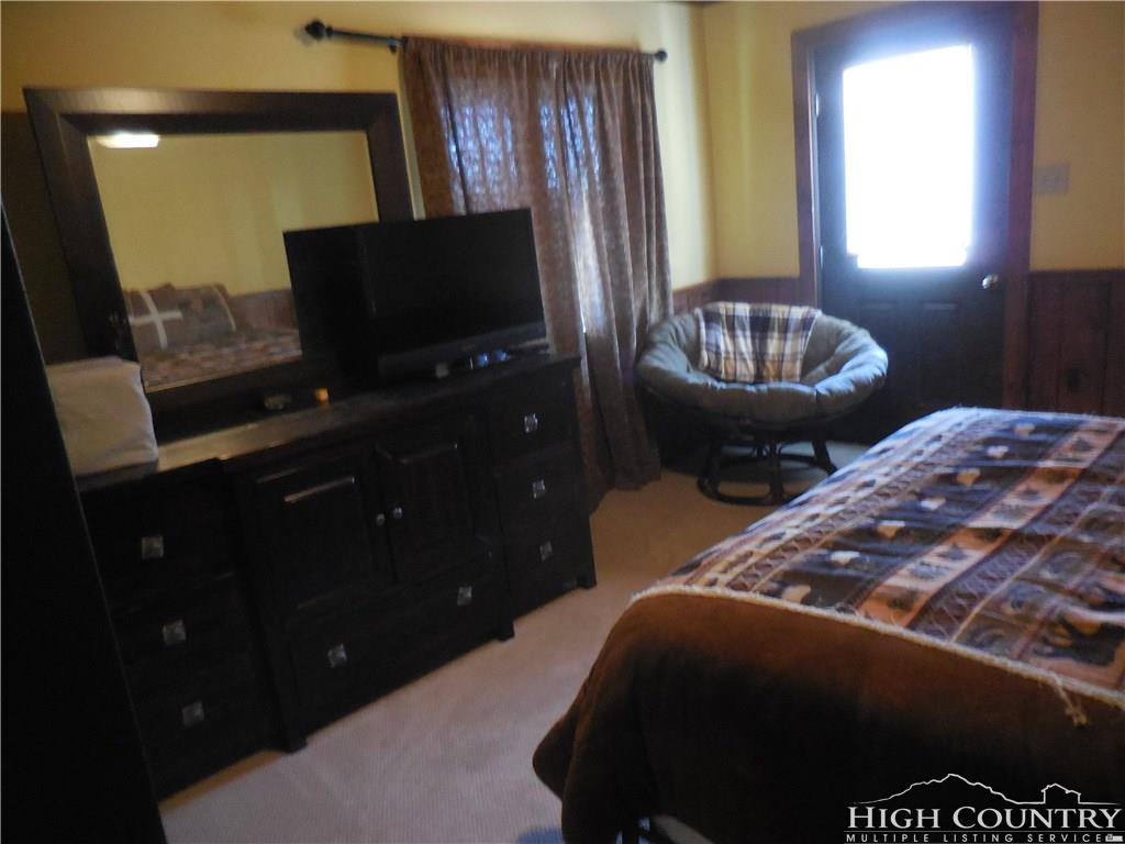 1071 Elk Hill Road Banner Elk, NC 28604 - Photo 17 of 28 a bedroom with two beds and a flat screen tv