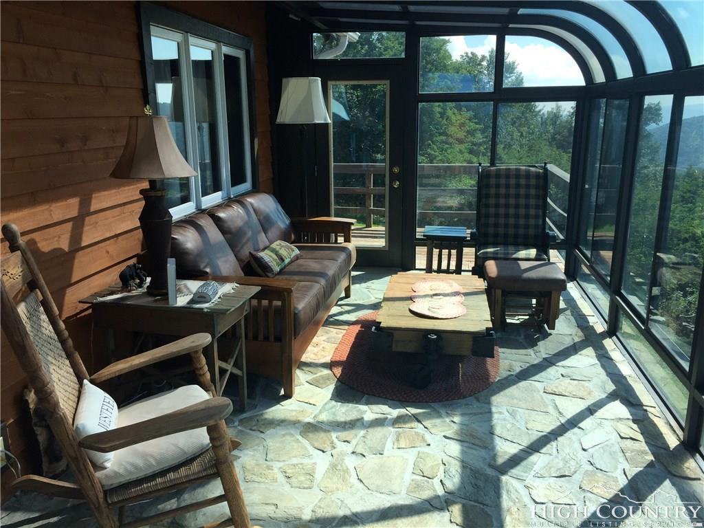 1071 Elk Hill Road Banner Elk, NC 28604 - Photo 5 of 28 a living room with furniture and a floor to ceiling window