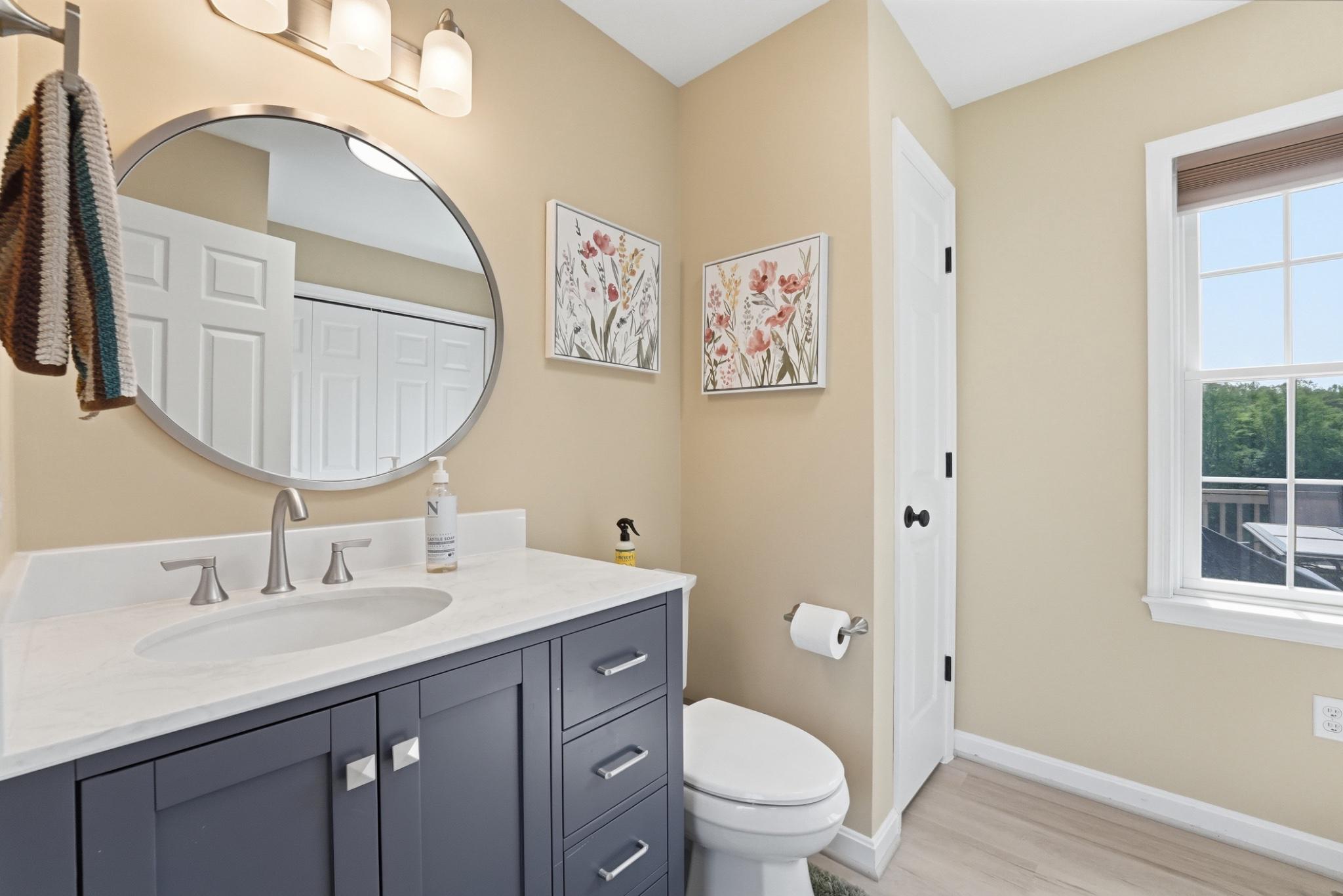 11337 Old Stillhouse Road Boston, VA 22713 - Photo 31 of 58 a bathroom with a toilet a sink and mirror