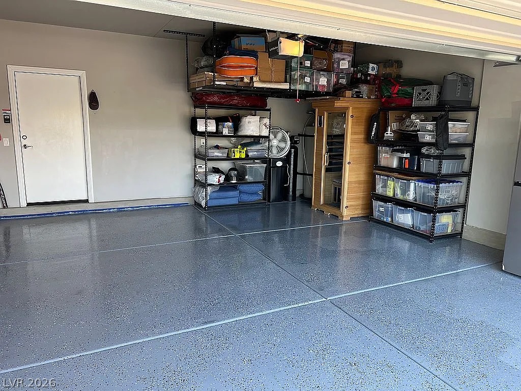1304 Cottage Ridge Mesquite, NV 89034 - Photo 27 of 52 Ample storage solutions and a pristine epoxy floor highlight this functional garage space.