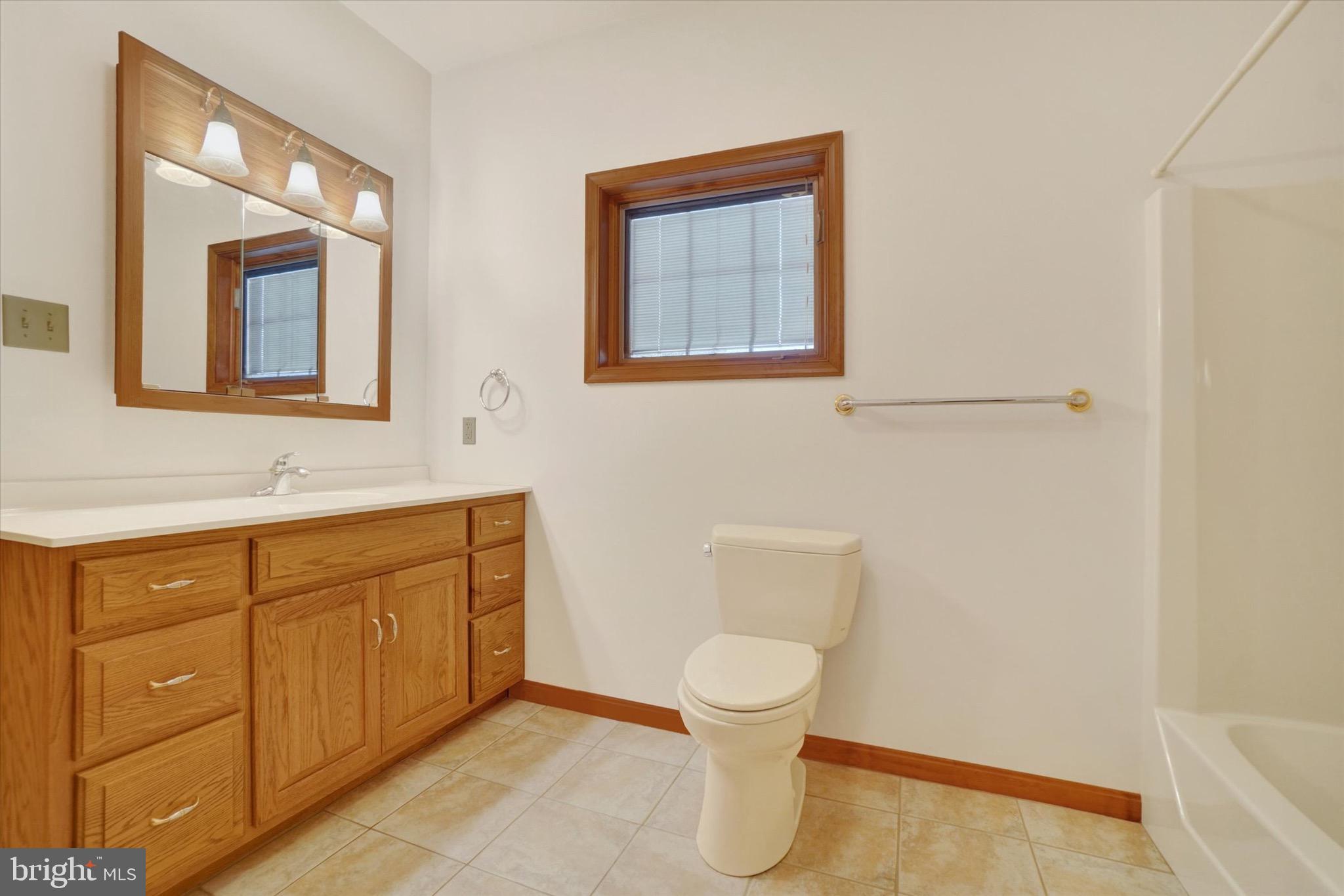 1100 Millcreek Road York, PA 17404 - Photo 27 of 44 a bathroom with a toilet sink vanity and mirror