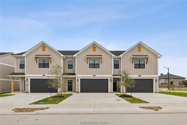 a view of house with outdoor space and parking