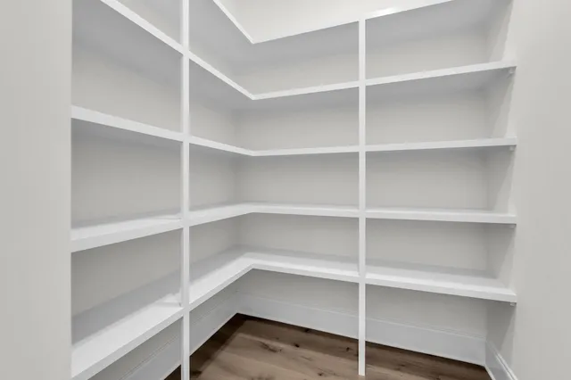 a spacious bathroom with a granite countertop sink a mirror and shower