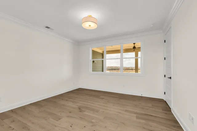 a front view of a building with garden and a garden