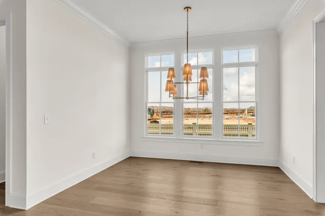 an empty room with windows and a fireplace
