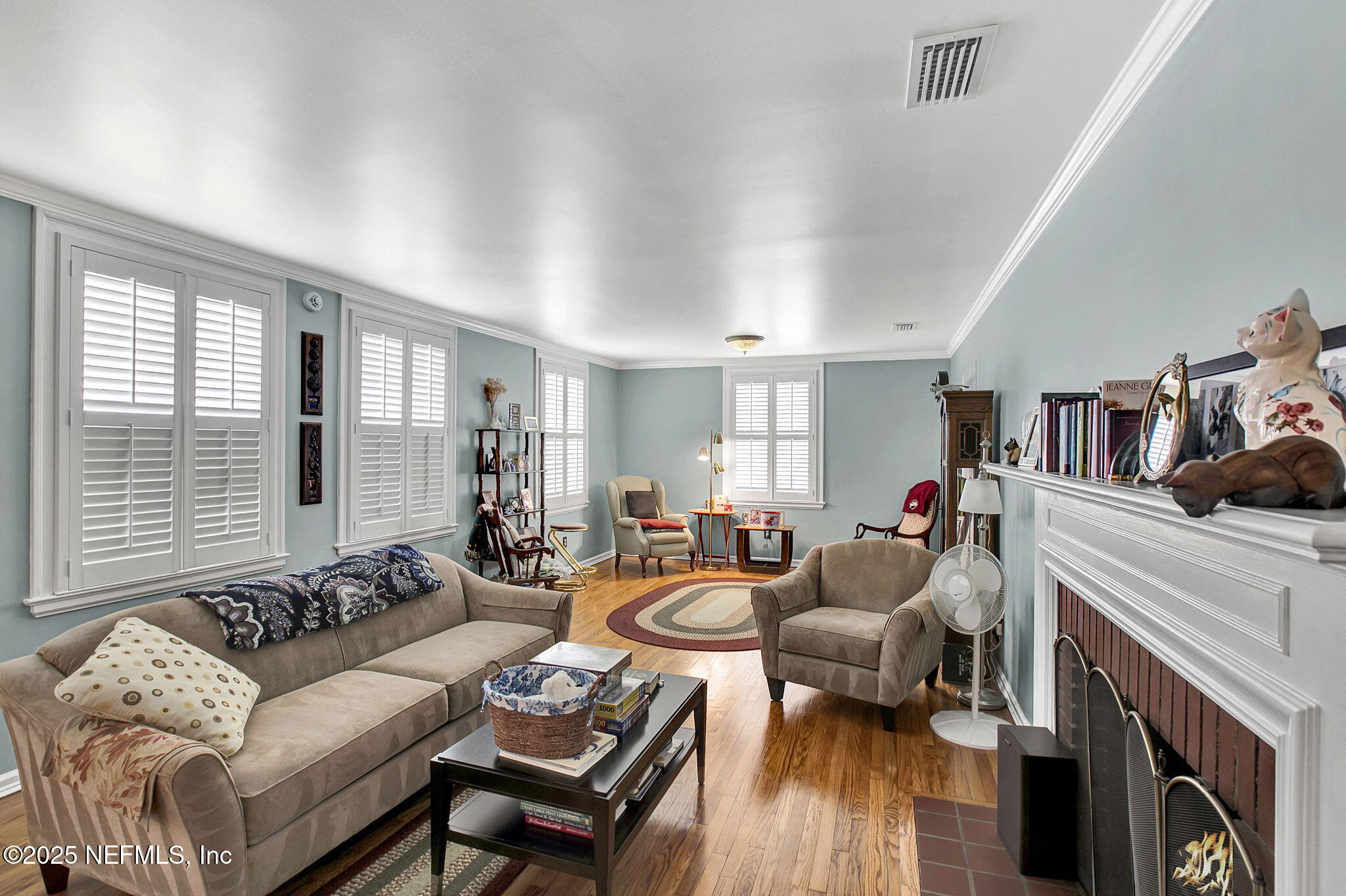 1105 South Shores Road Jacksonville, FL 32207 - Photo 9 of 31 a living room with furniture a fireplace and a large window