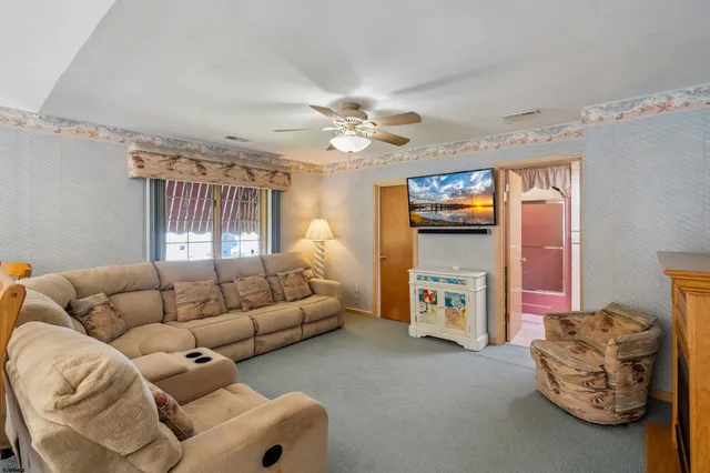 a room with pool table and wooden floor