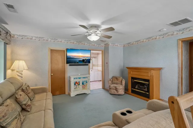 a living room with furniture a rug and a chandelier