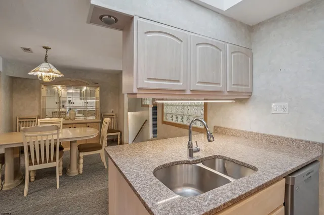 a dining room with furniture a chandelier and window