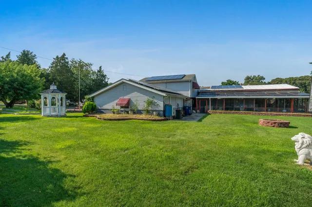 an aerial view of a house with a garden and swimming pool
