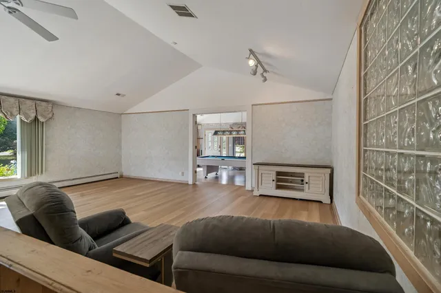 a living room with furniture and a wooden floor