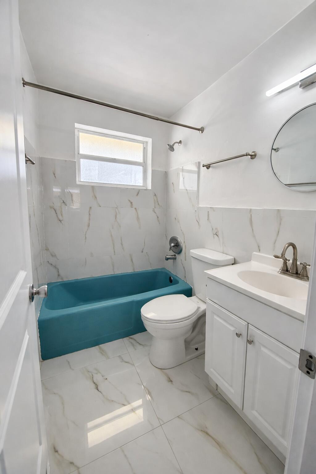 635 Southwest 14th Terrace, Unit 19 Fort Lauderdale, FL 33312 - Photo 3 of 8 a bathroom with a sink a toilet and a bathtub