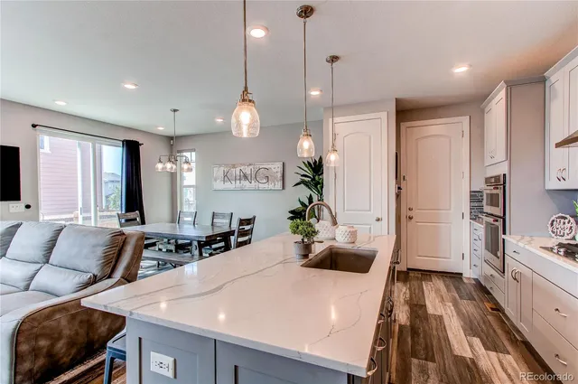 a large kitchen with a table and chairs