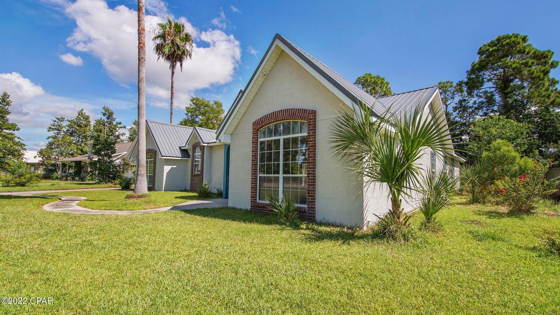 104 Colony Harbour Road Panama City Beach, FL 32407 - Photo 13 of 75 a front view of a house with garden