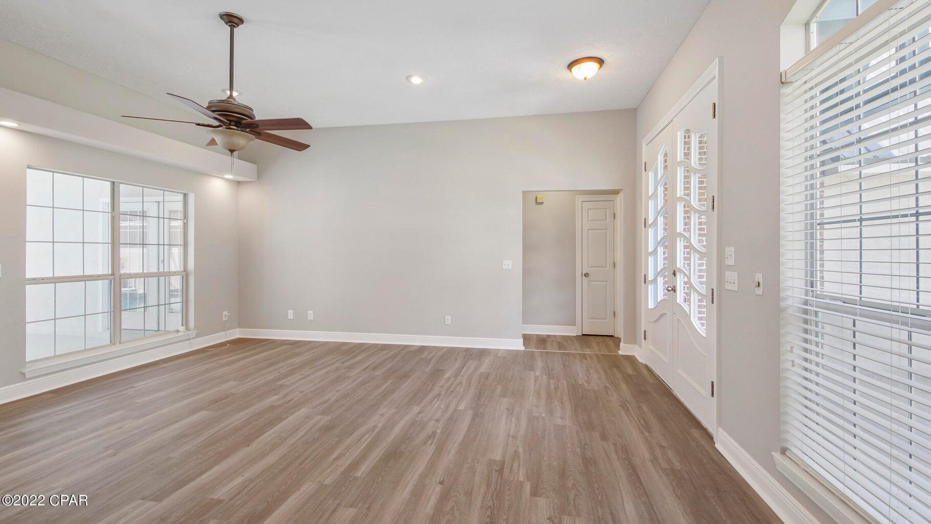 104 Colony Harbour Road Panama City Beach, FL 32407 - Photo 18 of 75 a view of empty room with wooden floor and fan