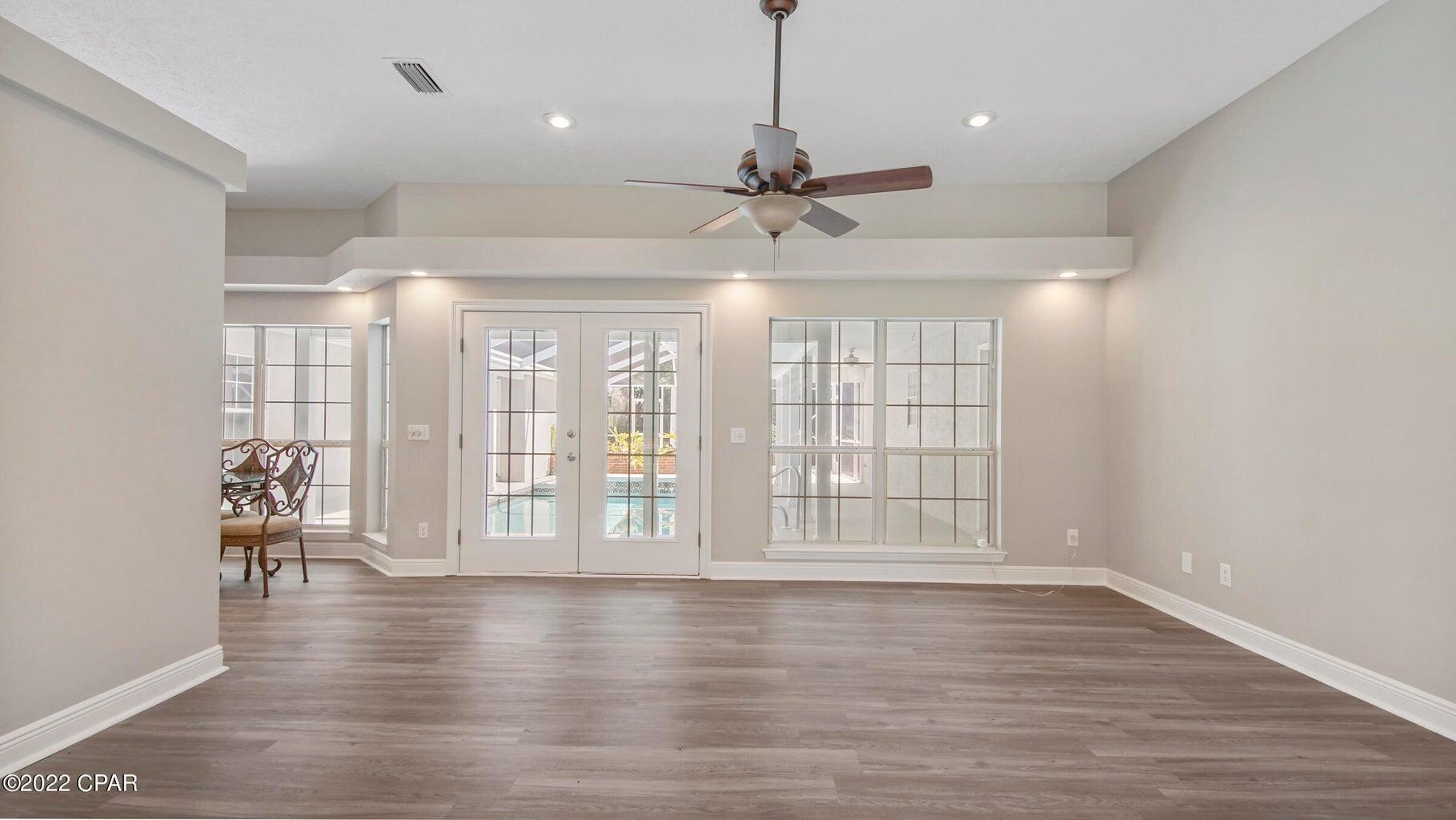 104 Colony Harbour Road Panama City Beach, FL 32407 - Photo 19 of 75 a view of an empty room with wooden floor and a window