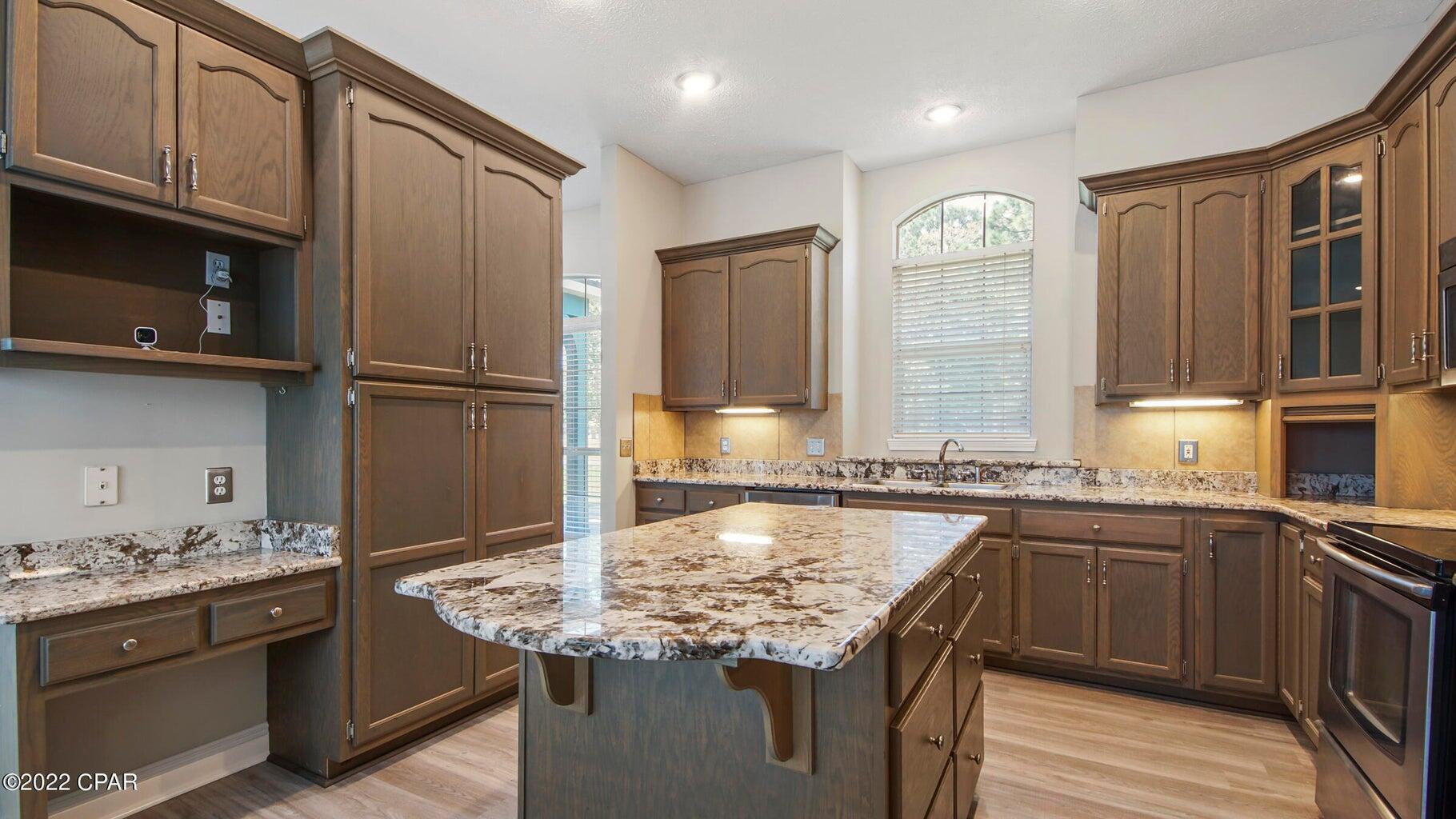 104 Colony Harbour Road Panama City Beach, FL 32407 - Photo 21 of 75 a kitchen with stainless steel appliances granite countertop a sink stove and refrigerator