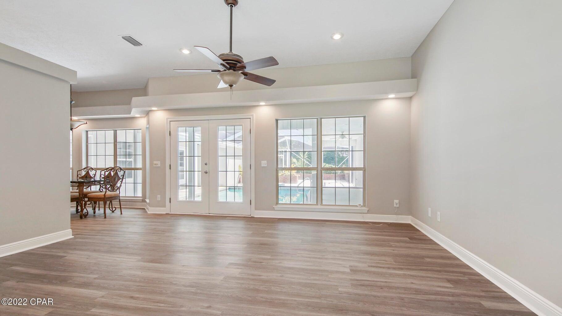 104 Colony Harbour Road Panama City Beach, FL 32407 - Photo 28 of 75 a view of an empty room with wooden floor and a window