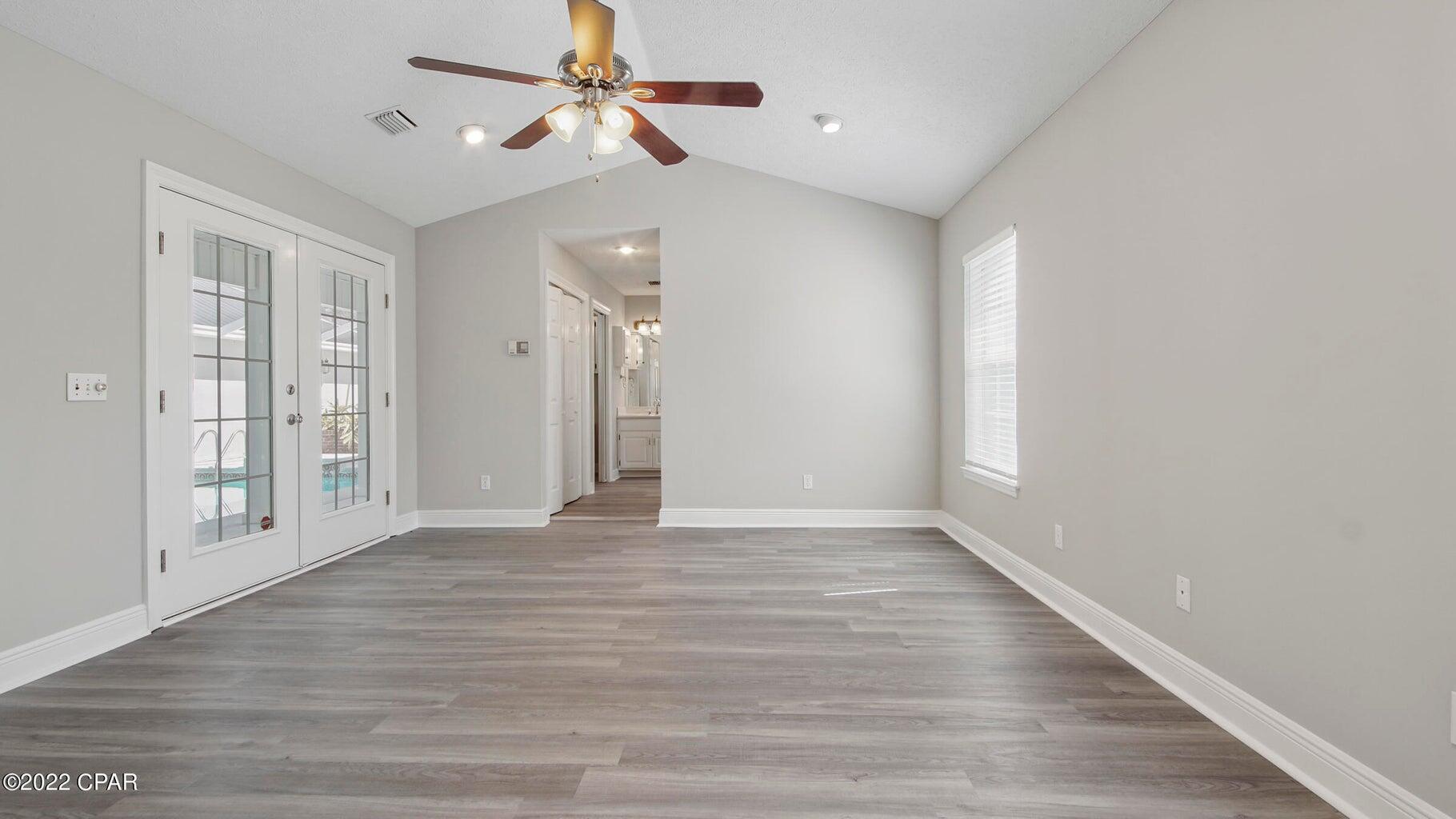 104 Colony Harbour Road Panama City Beach, FL 32407 - Photo 30 of 75 a view of an empty room with window and wooden floor