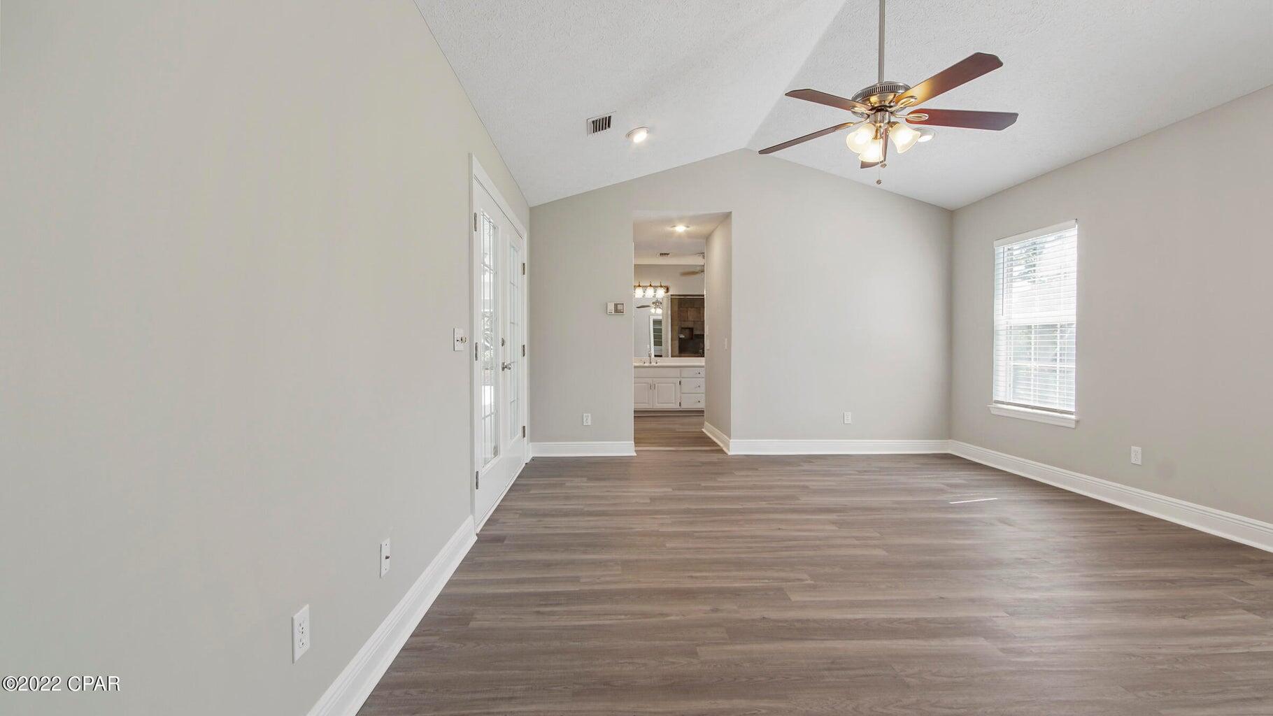 104 Colony Harbour Road Panama City Beach, FL 32407 - Photo 31 of 75 wooden floor in an empty room with a window