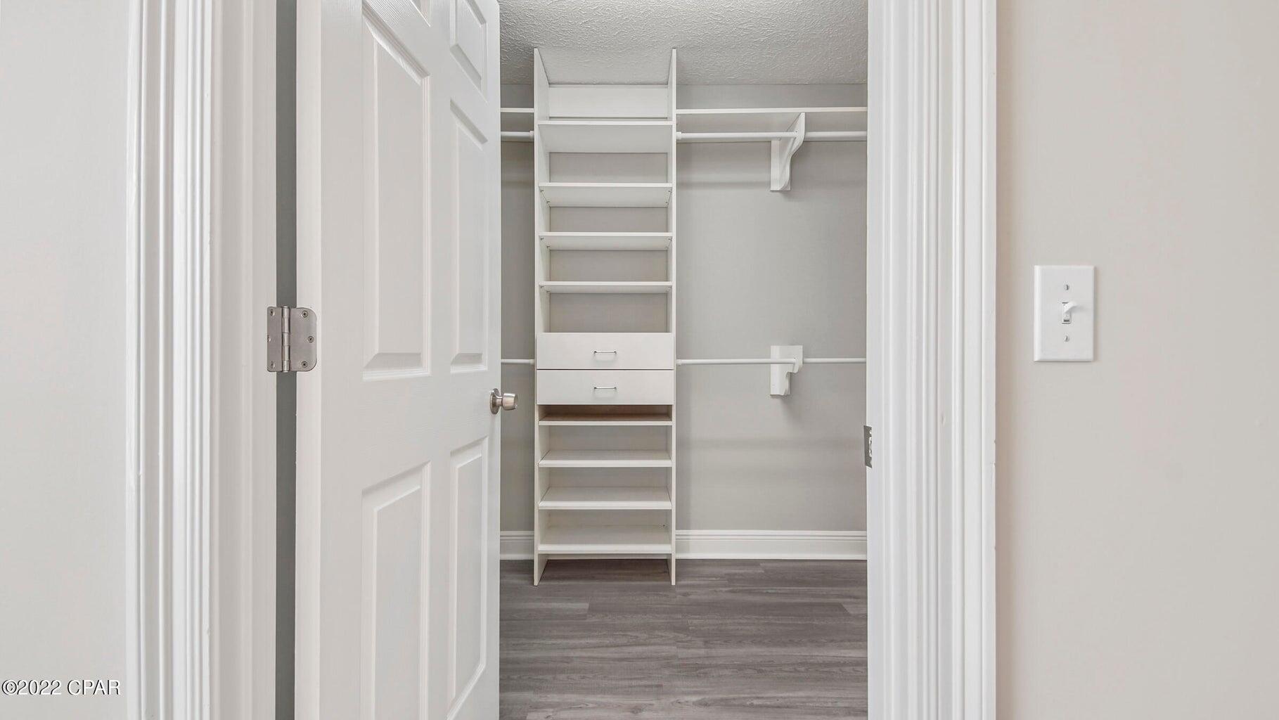 104 Colony Harbour Road Panama City Beach, FL 32407 - Photo 33 of 75 a view of walk in closet with empty racks