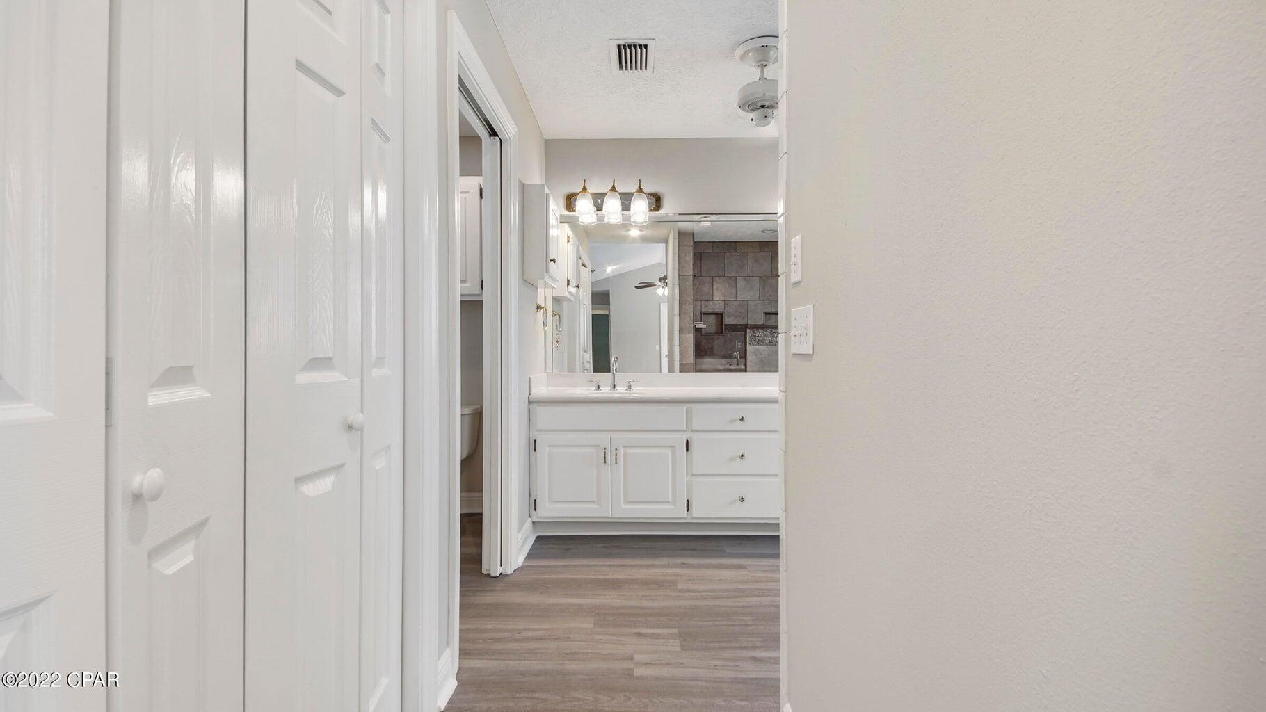 104 Colony Harbour Road Panama City Beach, FL 32407 - Photo 34 of 75 a bathroom with a sink and a mirror