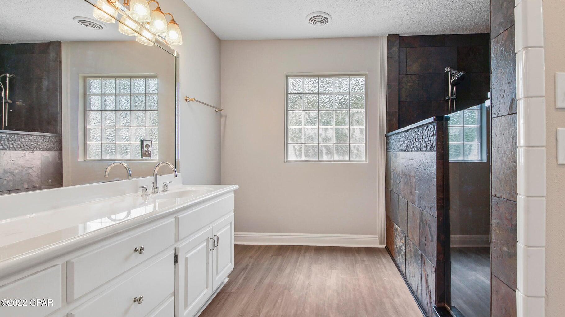 104 Colony Harbour Road Panama City Beach, FL 32407 - Photo 35 of 75 a bathroom with a granite countertop sink toilet and shower