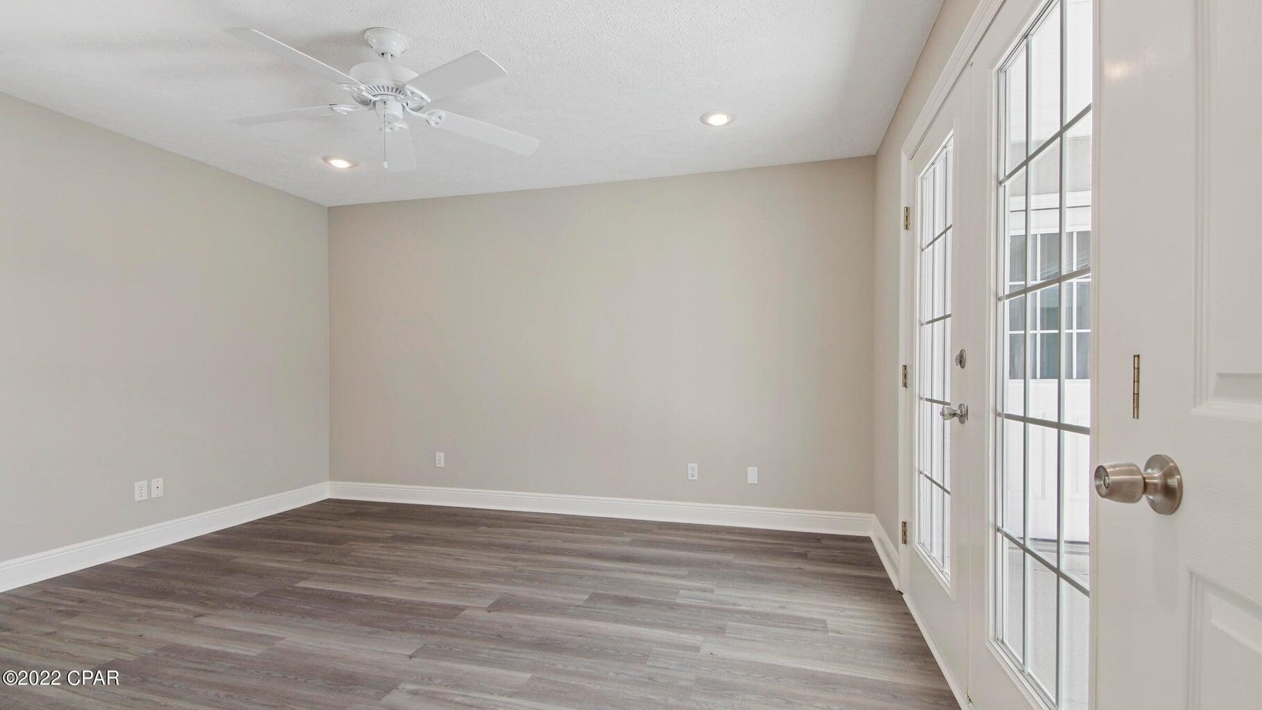 104 Colony Harbour Road Panama City Beach, FL 32407 - Photo 39 of 75 wooden floor in an empty room with a window