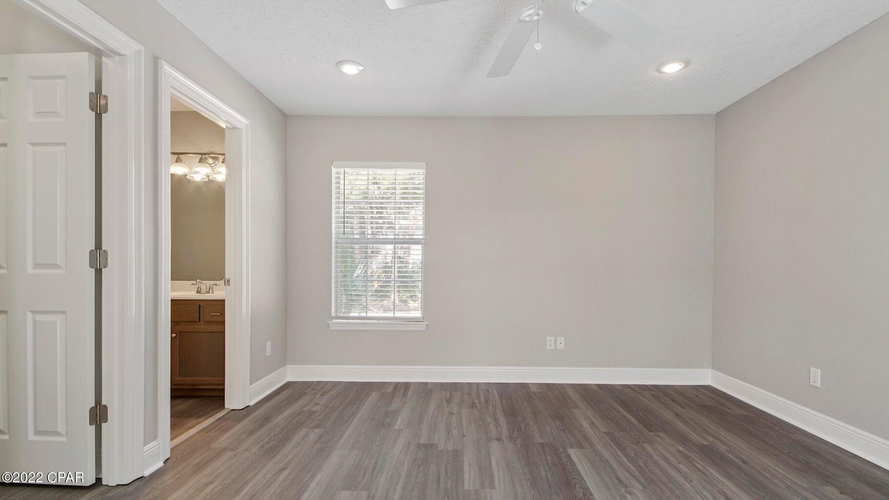 104 Colony Harbour Road Panama City Beach, FL 32407 - Photo 40 of 75 an empty room with wooden floor and windows