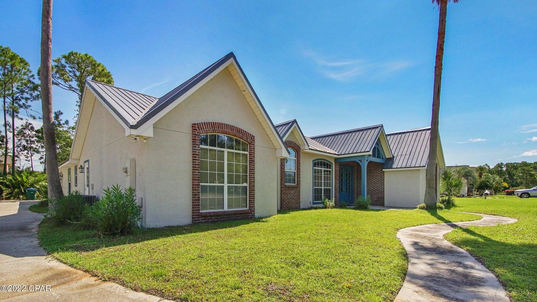 104 Colony Harbour Road Panama City Beach, FL 32407 - Photo 4 of 75 a view of a house with backyard and garden