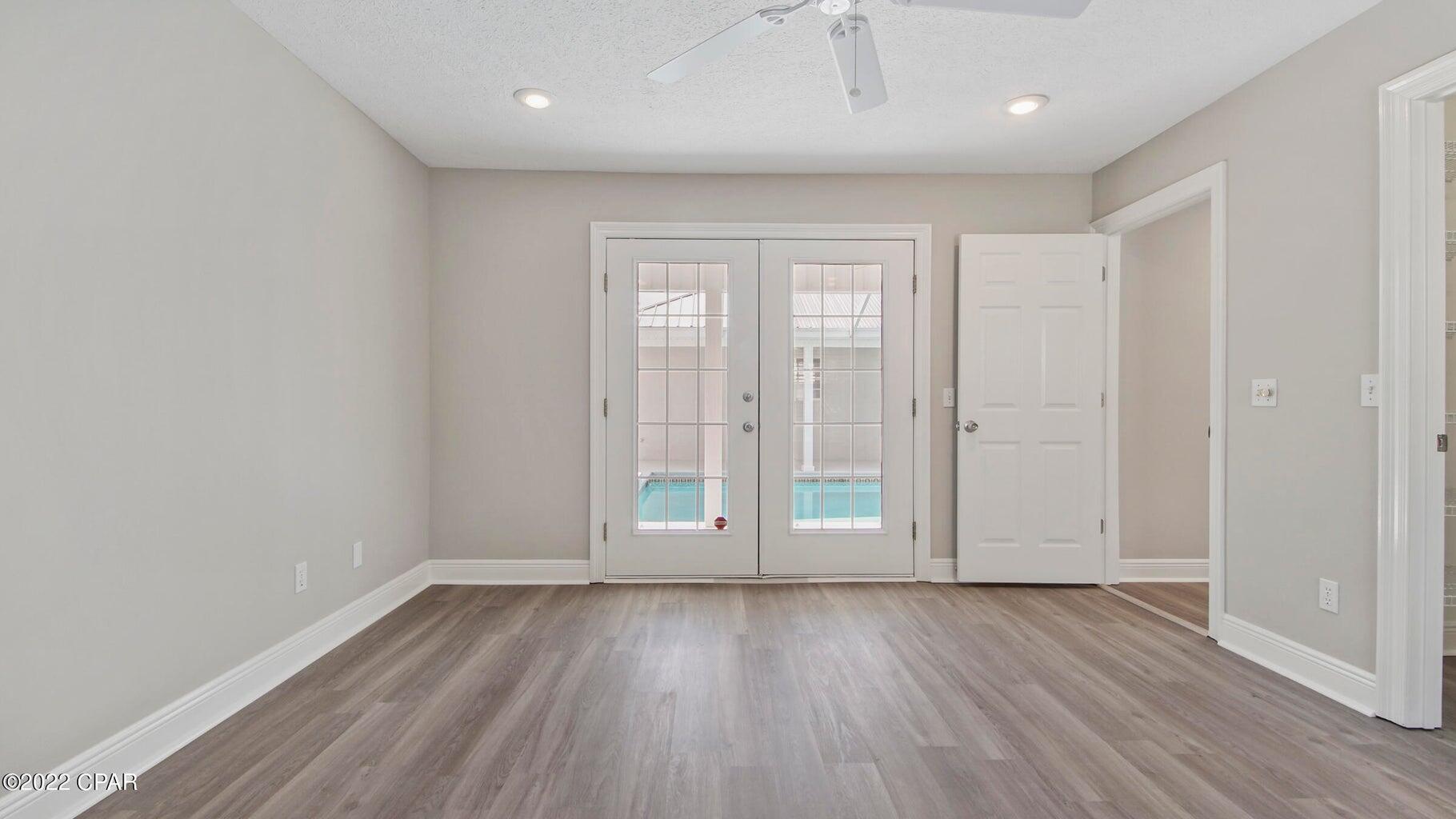104 Colony Harbour Road Panama City Beach, FL 32407 - Photo 42 of 75 wooden floor in an empty room with a window