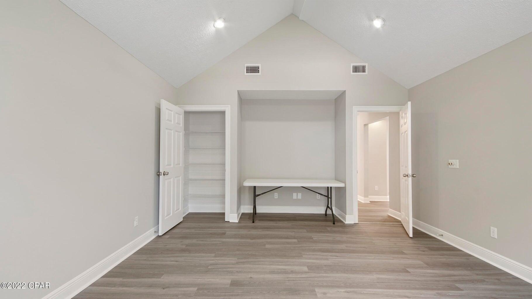 104 Colony Harbour Road Panama City Beach, FL 32407 - Photo 44 of 75 a view of an empty room and wooden floor