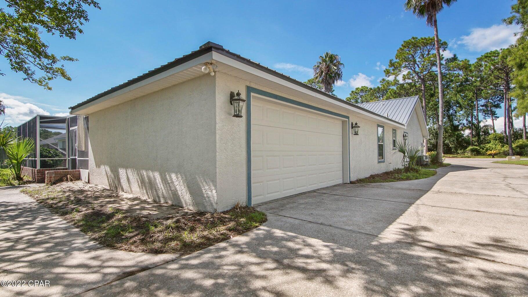 104 Colony Harbour Road Panama City Beach, FL 32407 - Photo 54 of 75 a front view of a house with a yard