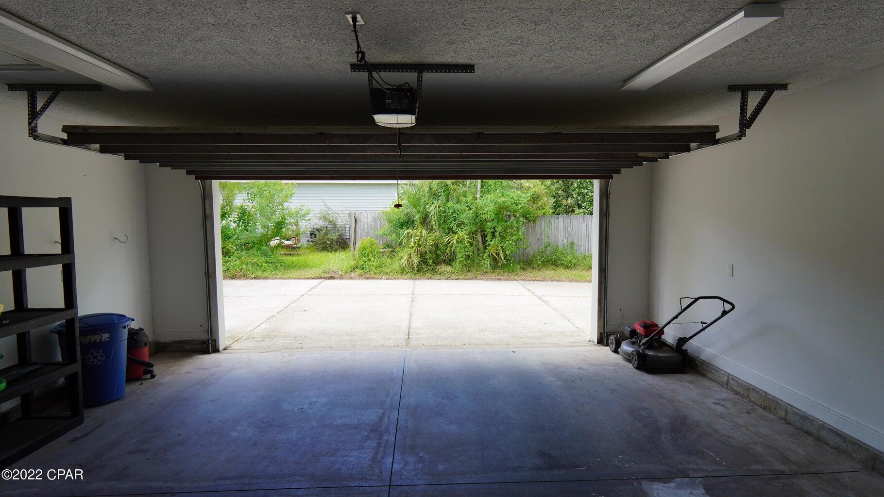 104 Colony Harbour Road Panama City Beach, FL 32407 - Photo 56 of 75 a view of a room with a large bed and wooden floor