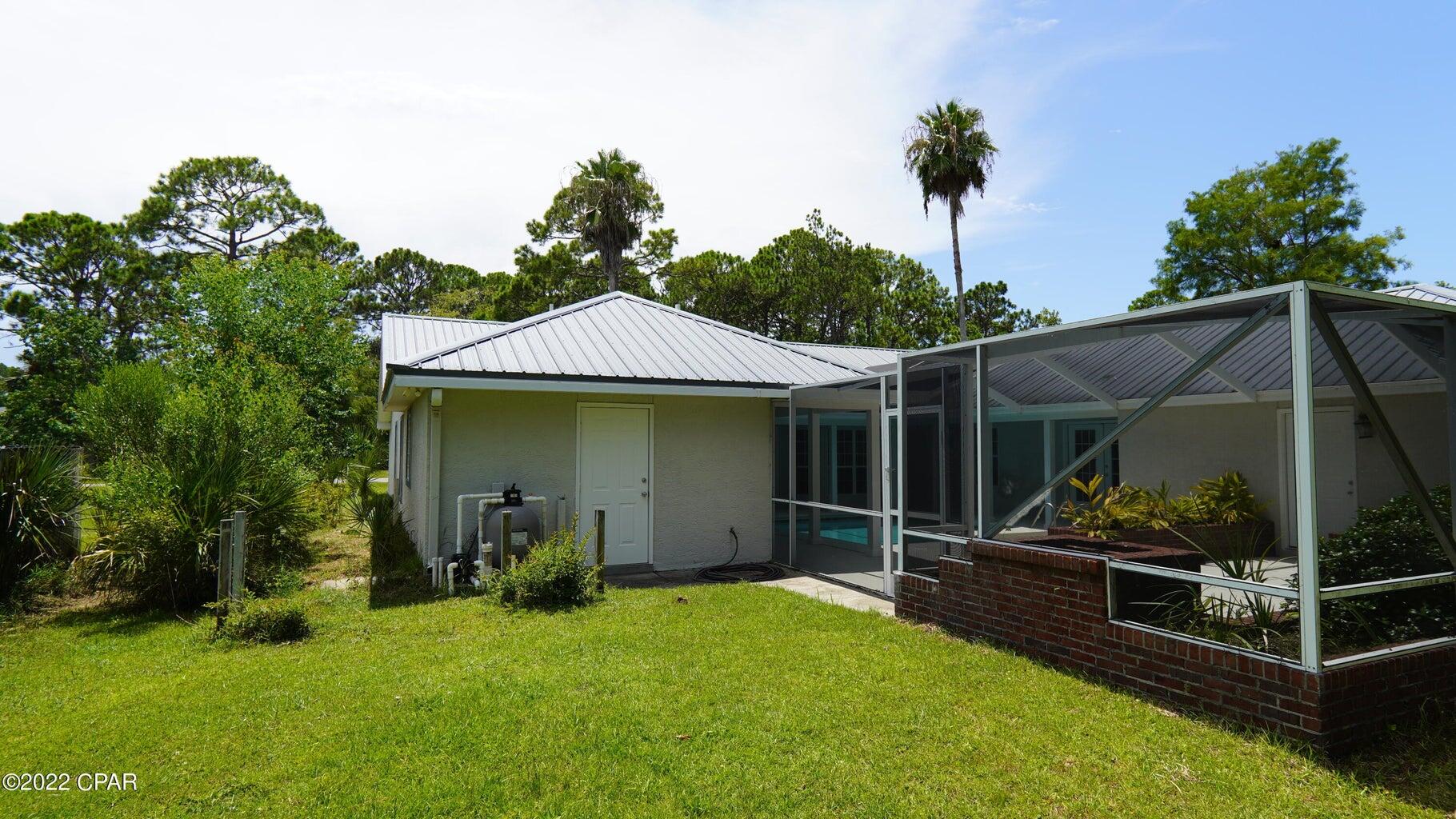 104 Colony Harbour Road Panama City Beach, FL 32407 - Photo 63 of 75 a view of a house with backyard and porch