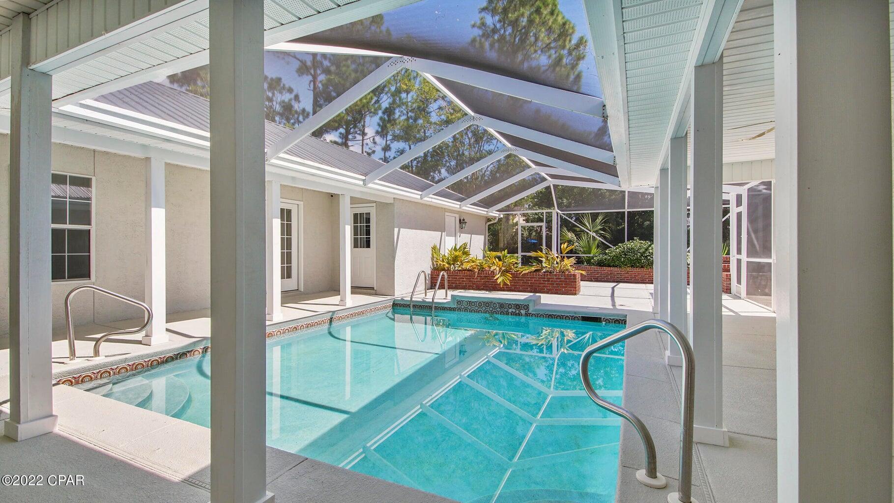 104 Colony Harbour Road Panama City Beach, FL 32407 - Photo 66 of 75 a view of a swimming pool with seating area
