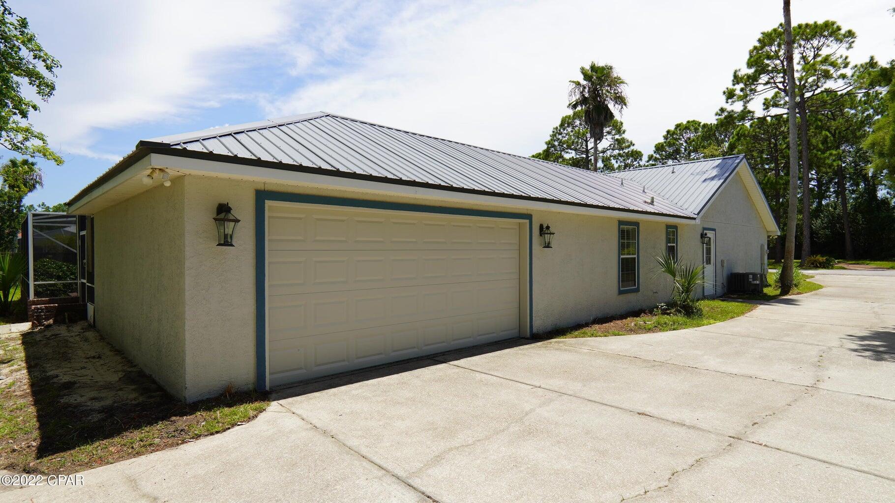 104 Colony Harbour Road Panama City Beach, FL 32407 - Photo 70 of 75 a front view of a house with garage
