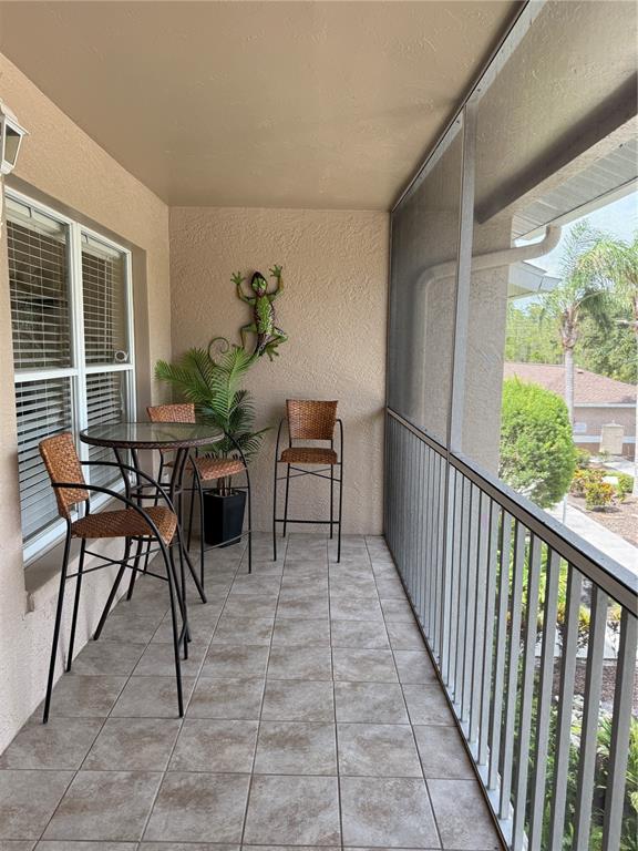 5320 Hyland Hills Avenue, Unit 2222 Sarasota, FL 34241 - Photo 3 of 29 a balcony with furniture and a potted plant