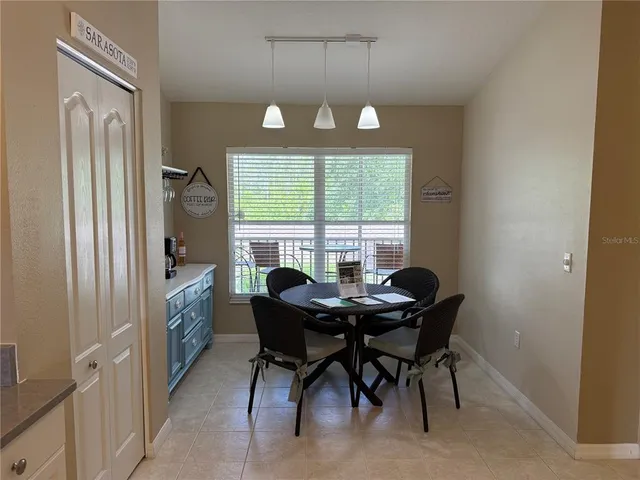 a view of a dining room with furniture window and outside view