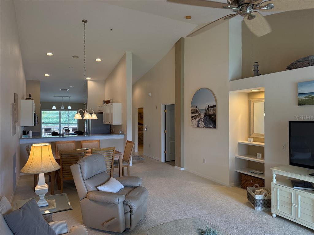 5320 Hyland Hills Avenue, Unit 2222 Sarasota, FL 34241 - Photo 7 of 29 a living room with furniture and a flat screen tv