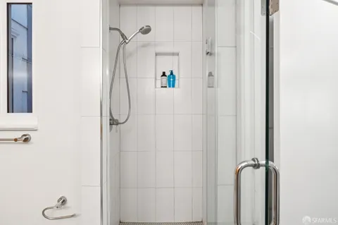a bathroom with a glass shower door