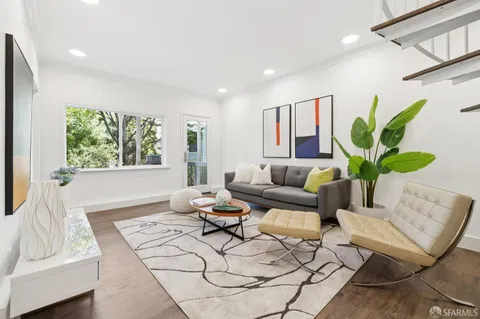 a living room with patio furniture and a large window