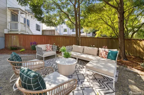 a view of a patio with couches chairs and a fire pit