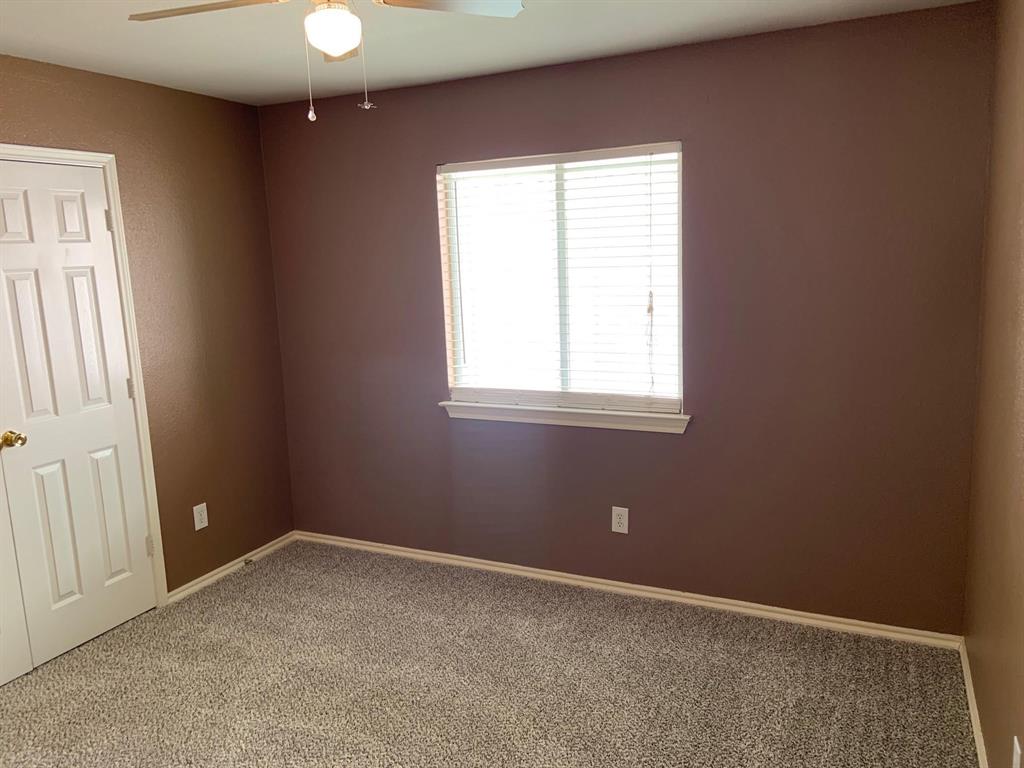 2620 Caprock Road McKinney, TX 75071 - Photo 10 of 19 Empty room with a ceiling fan and light colored carpet