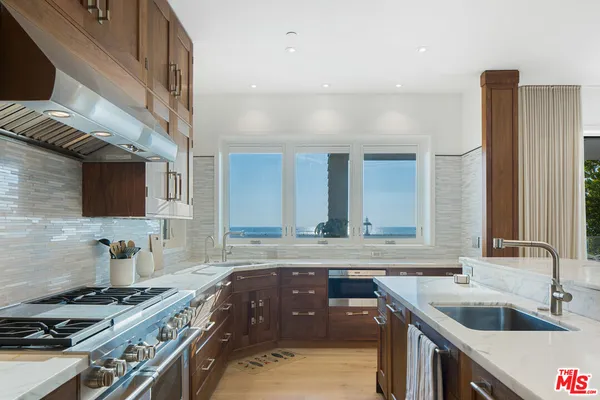 a view of a patio with a dining table and chairs with wooden floor