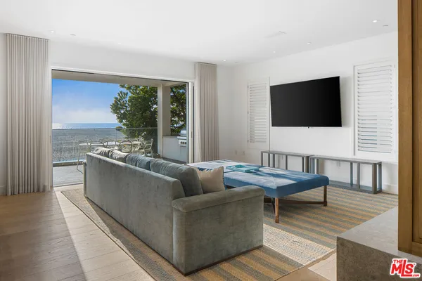 a view of a livingroom with furniture and a window